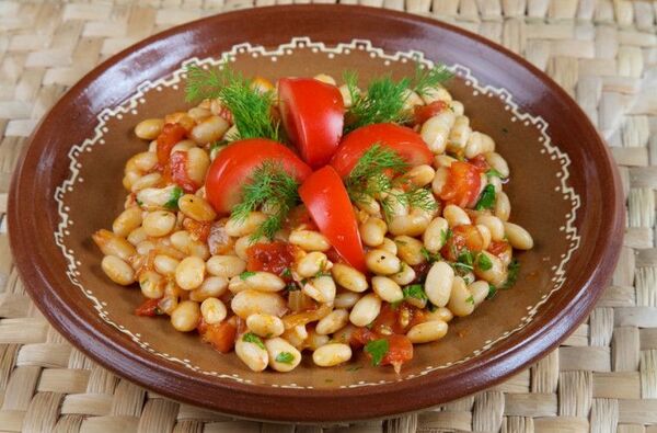 Colorful bowl with vegetables, grains, and herbs